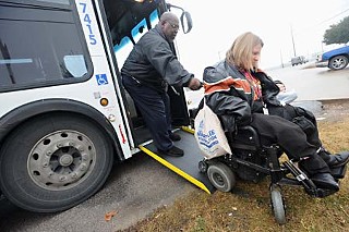 A Sunset Commission report describes Cap Metro's public outreach as inadequate and says the agency's working relationship with the disability community is in serious disarray. Here, a bus driver struggles to help ADAPT of Texas member Jennifer McPhail navigate a ramp.