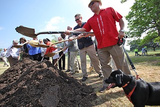 Mayor Pro Tem Mike Martinez, under the watchful eye of his dog Chucho, joins in the May 7 groundbreaking of a new $12 million animal center – the Betty Dunkerley Campus – just west of U.S. 183 near Airport Boulevard. The 41,450-square-foot center is slated for completion in late 2011.