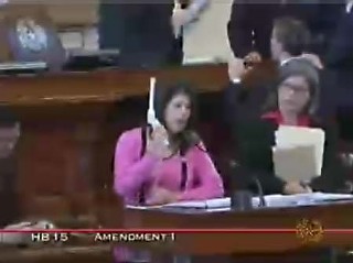 Rep. Carol Alvarado, D-Houston, wields an ultrasound probe at the front podium; not even a horribly outdated streaming video can disguise the size of this tool.