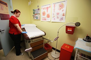 Nurse Holli Jackson readies an exam room at Planned Parenthood's East Seventh Street clinic, which will receive zero funding from the state.