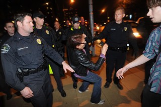 Fifty-eight-year-old Claire Hirschkind falls to the ground as police surround her during the Feb. 3 arrests of Occupy Austin members. See <b><a href=http://www.austinchronicle.com/news/2012-02-10/convictions-stand-despite-eviction/>Convictions Stand, Despite Evictions</a></b>.