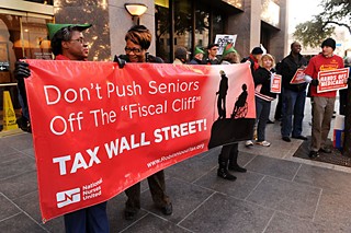 A crowd gathers outside Sen. John Cornyn's office on Dec. 10. The protesters sought the renewal of tax cuts for the middle class, and the protection of such social programs as Medicare, Medicaid, and Social Security.