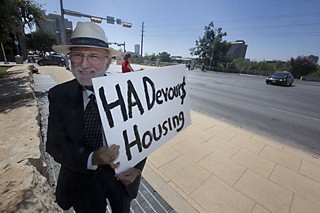 Chuck Ragland demonstrates against short-term rentals in front of City Hall in August.