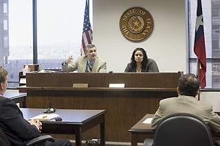 Administrative Law Judges Craig Bennett (l) and Pratibha Shenoy listen to attorneys at a brief hearing March 1, shortly before the City Council's approval of the settlement the same day.