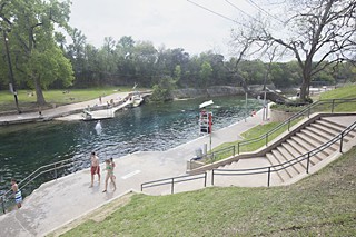 Swimmers enjoy the first day of Barton Springs Pool's reopening March 30. The pool had been closed since December for repairs on the bypass culvert and downstream dam. Two days later it was closed again due to Tuesday's heavy rainfall.
