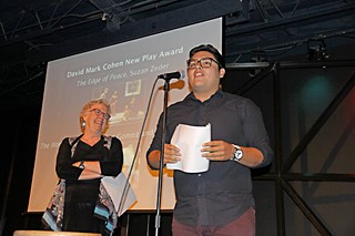 Recent UT graduate Isaac Gomez accepts the David Mark Cohen New Play Award for <i>The Women of Juarez</i>, which he co-wrote with Bianca Sulaica. Looking on is Gomez's mentor, retiring UT playwriting professor Suzan Zeder, who shared the award for <i>The Edge of Peace</i>, the conclusion to her Ware Trilogy. Gomez was also one of five recipients this year of the W.H. Deacon Crain Award for Outstanding Student Work.