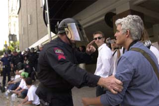 <i>Austin Chronicle</i> photographer Jana Birchum is manhandled by an Austin police officer at Monday's protest.