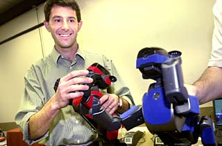 Dr. Peter Stone will lead a team of 20 graduate students and eight soccer-playing robots to the RoboCup VII American Open on April 30.