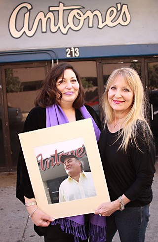Susan Antone and longtime club greeter Ilse Haynes with a portrait of Clifford Antone