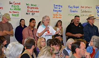 Citizens protest the groundwater well project during a Feb. 10 town hall meeting, hosted by state Rep. Jason Isaac.