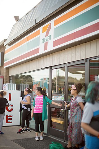 Students line up outside a 7-Eleven to promote healthy eating.