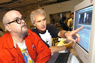 Steve Mims (r) shows Austin FilmWorks student Guy Juke the finer points of  editing software.