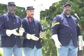 Buffalo Soldiers (l-r) Horace Williams, Rouzan Barton, and Ken Pollard from the 9th Cavalry Company A at Camp Mabry sing a tribute at the Juneteenth celebration Friday, June 18, in Woolridge Park.