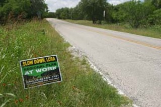 This sign on Hamilton Pool Road calls for the LCRA 
to delay its water pipeline decision until a regional plan 
is in place. If growth continues without a plan, the 
eastern segment of this little two-lane country road 
could see 20,000 car trips per day by 2030 (up from 
6,500 today) and would require widening to four lanes, 
according to Texas Department of Transportation 
reports.