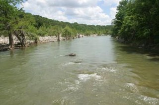 This view of the Pedernales River from Hammett's 
Crossing, a quaint low-water bridge constructed in the 
mid-Twenties, could change drastically over the next 
10 to 30 years. The bridge disappeared under water 
during heavy rains in November and could disappear 
altogether if new development and traffic continue 
pushing westward.