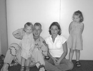  Ron and Crystal Luker with two of their daughters 
before Ron shipped back to Baghdad
<br>(photo courtesy of the Luker family)