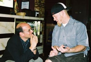 ThinkFilm President Jeff Sackman talks shop with his star in the lobby of the Crest Majestic theatre during <i>Murderball</i>'s L.A. premiere.
