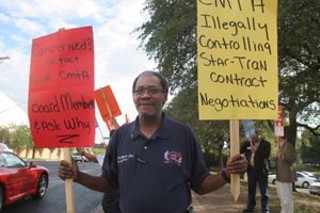 Jay Wyatt, president of the Amalgamated Transit Union Local 1091, protests outside a meeting of the Capital Area Metropolitan Planning Organization on Monday.