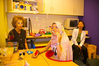 At Shriner's Hospital for Children in Houston, Asra'a was
fitted with a prosthetic arm. Physical therapists taught
her to perform simple tasks for herself for the first time
since her arm was severed by shrapnel from a U.S.
missile five years ago.