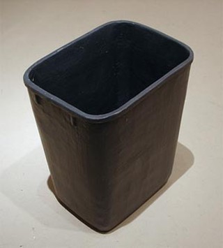 A Rubbermaid wastebasket, as carved from wood and painted by Conrad Bakker.