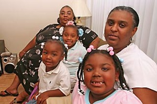 Diana Wallace (far left) with granddaughters Mya (back 
left) and Mia (front left) and niece Angel LaCour (front 
right) on the living room couch of sister Christine Braud 
(far right)