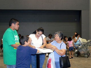Maria Estrada had a lot of help applying for Medicaid Saturday afternoon during the Texas Benefits Event. In addition to the state Health and Human Services workers on hand to answer questions, Estrada's daughter, Maria Morales, and her grandsons, Andre and Luis Garcia, all came with her to the Austin Convention Center to help her sign up. Estrada, who recently moved here from Tucson, Ariz., was applying for Medicaid in Texas for the first time, although many of the estimated 1,077 people who applied for Medicaid - as well as the Children's Health Insurance Program, food stamps, and Temporary Assistance for Needy Families - had previous trouble getting signed up.
<br>         As the first step in the state's much-touted plan for privatizing the public benefits eligibility and enrollment process, the Texas Health and Human Services Commission changed last January how residents of Travis and Hays counties sign up for benefits. But the transition hasn't gone smoothly. Over the last six months, Travis County reported a 10% decline in children's Medicaid enrollment while Hays County had a 7.7% decline. State-wide enrollment declined by only 4%, according to a press release from the office of Rep. Elliott Naishtat, who sponsored the event along with other legislators. Most of the people here have gone without needed services because they've had problems enrolling or re-enrolling, Naishtat said at the event. The privatization program's expansion into other counties has been delayed as a result of the glitches. Most of the people at the Convention Center Saturday applied for food stamps and Medicaid, said Nancy Walker, one of the event's coordinators and Naishtat's legislative director.