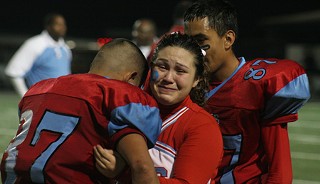 Johnston senior Gabby Camarillo consoles Art Jimenez after the Ram's homecoming game loss to Lanier. The Rams were forced to forfeit much of the season due to injuries and academic disqualifications.