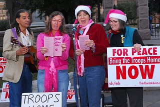 Local anti-war activists Daniel Llanes, Fran Hanlon, Carol Petrucci, and Alice Embree sang carols in front of the Capitol Friday, Dec. 21, to call attention to the Iraq Moratorium, a national effort to end the conflict in Iraq. Women in Black, CodePink, Austin Movement for a Democratic Society, and the Iraq Moratorium National Committee co-sponsored the protest. Supporters of the moratorium gather the third Friday of every month. For more info, check out <a href=http://www.iraqmoratorium.org/>www.iraqmoratorium.org</a>.