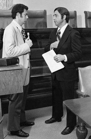 Austin Municipal Judge Ronnie Earle talks with a radio reporter, circa 1973.