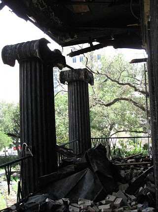 The charred remains of the second floor balcony of the Governor's Mansion