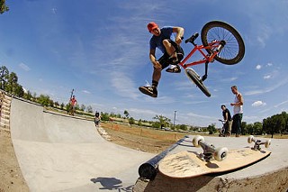 Taj Mihelich performs a tailwhip on the new miniramp at Patterson Park, across from Mueller. The ramp, open to skateboard and BMX riders, is part of a long-range effort to provide a citywide network of public skateboarding facilities. The Austin Public Skatepark Action Committee completed the Patterson ramp project with donated funds and volunteer construction labor.