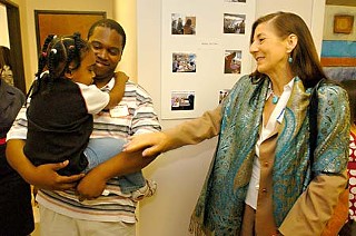 District Court Judge Darlene Byrne (r) greets Lamont Fisher and his daughter, Tiana, at a June 24 open house for two new Travis County offices – one representing children and the other representing parents. The new departments, which represent families involved in Child Protective Services court cases, draw initial funding from a three-year grant from the Court Improvement Program of the Texas Supreme Court. Leslie Hill heads the child representation office, while Stephanie Smith Ledesma leads the office representing parents.