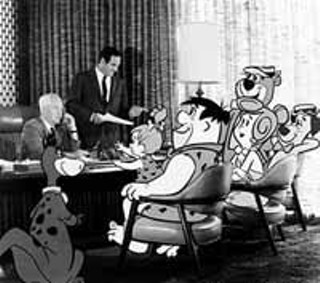 Bill Hanna (seated) and Joe Barbera with their cartoon creations
