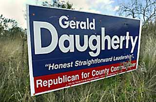 Pct. 3 Republican hopeful Gerald Daugherty is all about R.O.A.D. -- specifically, Reclaim Our Allocated Dollars, a nonprofit organization he founded in order to defeat Capital Metro's 2000 light-rail referendum. But in his bid for a seat on the Commissioners Court, has he forgotten that the roadside isn't his alone? Sprawling signs such as this one, located off the southbound access road of MoPac between Spyglass and Barton Springs Mall, are much larger than typical campaign signs. Some Austinites have contacted the <i>Chronicle</i> complaining about Daugherty's billboards. Signs posted in right-of-ways violate the city code.