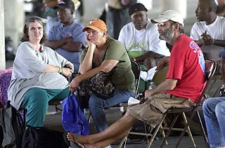 Sunday morning worship service under the I-35 bridge between Sixth and Seventh streets