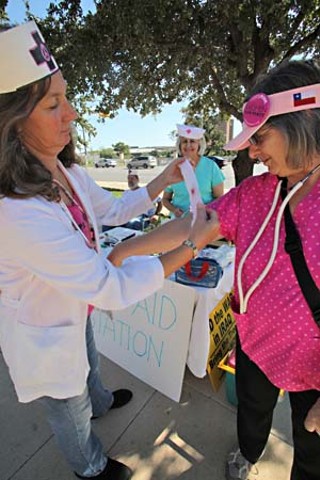 Code Pink members Fran Hanlon and Alice Embree joined Texans for Peace activists at City Hall Plaza Oct. 17 to demand that the federal government shift funding from war efforts to pay for health care coverage for all Americans.