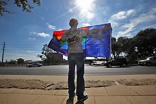 A demonstrator holds a gay flag bearing a Texas-style Lone Star at a Nov. 7 event protesting the Nov. 4 passage of a referendum in Maine banning same-sex marriage. The demonstration was sponsored by Join the Impact-Austin.