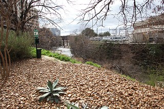 The Arguments for Nueces: 
Rio Grande dead-ends at Shoal Creek, which would require another bridge to be built or signage directing cyclists around the block to the existing bridge.