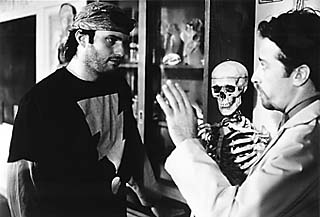 Photograph of Rodriguez and Stewart having a talk in front of a skeleton