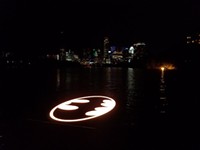 Batman’s Iconic Emblem Lights up Lady Bird Lake for Caped Crusader’s 80th Anniversary