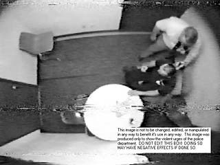 Police videotape of Michael Scott's interrogation apparently shows APD Detective Robert Merrill holding a gun to Scott's head. Merrill testified he was role-playing, and held his fingers to Scott's head while holding his gun in the other hand.
