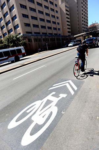 Retreating from earlier plans to turn Nueces into a bike boulevard, city officials have opted instead to install bike lanes and sharrows, like this campus-area marking on Dean Keeton.