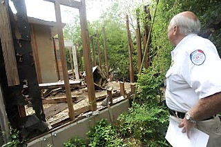 Acting on a complaint, Austin Code Enforcement Officer Malcolm Mills checks out a remodeling project at 1915 David; Mills said he referred the case back to the city permit office. Members of the Original West University Neighborhood Association say the project is moving forward only because of a remodeling regulation loophole, even though it will ultimately increase the size and occupancy level of a structure surrounded by single-family homes.