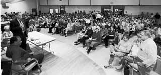 U.S. Rep. Lloyd Doggett (l) interacts with an overflow crowd at a Town Hall meeting about Iraq last Saturday morning. At the forum, held at the First Unitarian Universalist Church and sponsored by the Gray Panthers, Doggett blasted the Bush administration's drive for war and said that it had failed to make a justifiable case for invading Iraq. See War Drums.