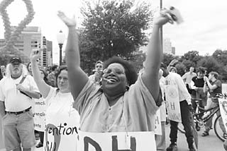 Activists, AIDS organization employees, and people with HIV/AIDS protest the Texas Department of Health's funding allocations for AIDS service organizations in the year 2002-2003 on Saturday. Funds were slashed and directed solely at target populations, such as African-Americans in the Rio Grande Valley, causing major service disruptions and loss of services in many areas.