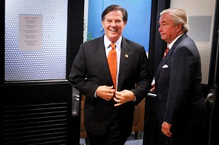 Who's grinning now? Tom DeLay and his attorney Dick DeGuerin before the former U.S. House Majority Leader was convicted of money laundering