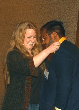 Heather Tolleson, the 2009 Artist of the Year Early Career, bestows the honor on this year's winner, Carlos Rosales-Silva.