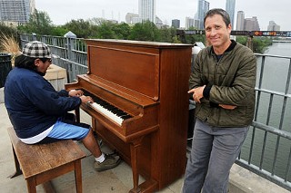 Artist/piano technician Johnny Walker and passerby Francisco Chavez playing the piano at the Play Me, I'm Yours project on the Pfluger Pedestrian Bridge
