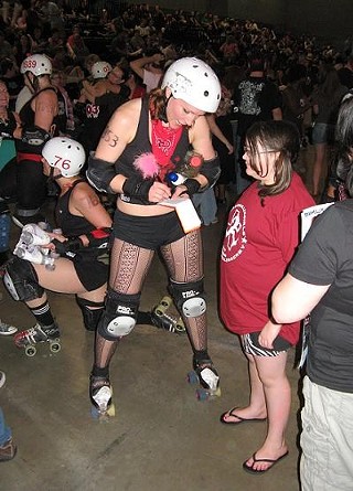 Curvette (kneeling) and Vicious Van GoGo of the Texecutioners post-bout with the fans
