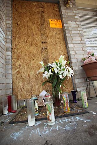 Flowers and candles at the home where Maria and Norma Hurtado were murdered April 18